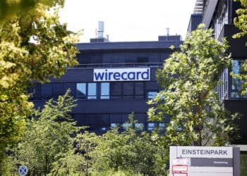 The Wirecard AG logo sits on the company's headquarters during a raid with prosecutors in Munich, Germany, on Wednesday, July 1, 2020. Wirecard offices in Germany and two locations in Austria were raided by Munich prosecutors looking into the 1.9 billion euros ($2.1 billion) that went missing from the fintech companys accounts.