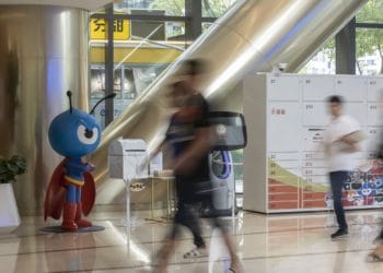 People walk past the Ant Group Co. mascot displayed at the company's headquarters in Hangzhou, China, on Monday, Sept. 28, 2020. Jack Ma's Ant Group is seeking to raise $17.5 billion in its Hong Kong share sale and won't seek to lock in cornerstone investors, confident there will be plenty of demand for one of the largest equity deals in the financial hub, according to people familiar with the matter.