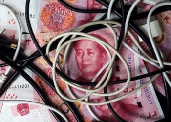 Cables sit on top of Chinese one-hundred yuan banknotes in an arranged photograph taken in Hong Kong, China, on Monday, April 15, 2019. China's holdings of Treasury securities rose for a third month as the Asian nation took on more U.S. government debt amid the trade war between the worlds two biggest economies. Photographer: Paul Yeung/Bloomberg