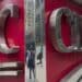 Pedestrians are reflected in signage on the exterior of the Canadian Imperial Bank of Commerce (CIBC) headquarters building in Toronto, Ontario, Canada, on Friday, May 19, 2017. Image via Bloomberg.