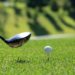Golf club teeing up a golf ball