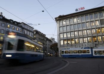 Trams pass by the UBS Group AG headquarters in Zurich, Switzerland, on Monday, Oct. 14, 2019. The spying scandal roiling Credit Suisse Group AG has also created a big headache at UBS a stone's throw away in
