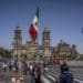 A Mexican flag flies at Constitution Square, known as Zocalo, in Mexico City, Mexico, on Friday Feb. 11, 2022.  Photographer: Alejandro Cegarra/Bloomberg