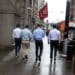 Pedestrians along Wall Street near the New York Stock Exchange (NYSE) in New York, U.S., on Monday, June 27, 2022. Money managers betting on a sustained global rebound will be left sorely disappointed in the second half of this crushing year as a protracted bear market looms, even if inflation cools. Photographer: Michael Nagle/Bloomberg