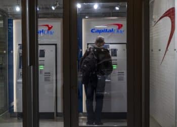 A customer uses an ATM inside a Capital One cafe branch in San Francisco on Jan. 20, 2022.