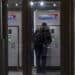 A customer uses an ATM inside a Capital One cafe branch in San Francisco on Jan. 20, 2022.
