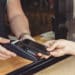 A person uses a digital card to complete a transaction.