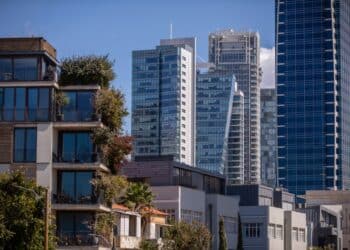 Residential apartment buildings back-dropped by high-rise residential and office buildings in the Neve Tzedek district of Tel Aviv, Israel, on Thursday, March 10, 2022. Real estate agents and immigration lawyers say theyve seen an explosion of inquiries from Russians who stand to benefit from an Israeli law that allows anyone with Jewish parents or grandparents to apply for citizenship. Photographer: Corinna Kern/Bloomberg