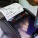 A customer makes a contactless card payment using a Barclays Plc debit card on a Worldpay Group Plc payment terminal in a retail outlet in London, U.K., on Friday, July 7, 2017. Photographer: Chris Ratcliffe/Bloomberg