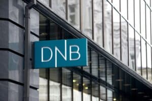 A DNB logo sits on display outside a DNB ASA bank branch in Vilnius, Lithuania, on Monday, Dec. 15, 2014. Lithuania will switch currencies to the euro on Jan. 1, 2015.