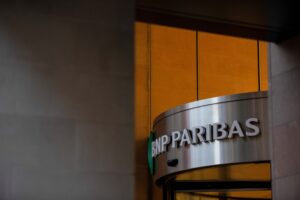 A sign at the entrance to the BNP Paribas SA headquarters in London, UK, on Thursday, May 19, 2022. BNP saw pickup in deposits in a flight to quality amid banking turmoil earlier this year, Chief Financial Officer Lars Machenil said in Bloomberg TV interview on May 3, 2023.