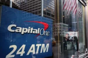 Pedestrians are reflected in the windows of a Capital One Financial Corp. bank branch in New York, U.S., Wednesday, Jan. 9, 2019. Capital One Financial Corp. is scheduled to release earnings figures on January 22.