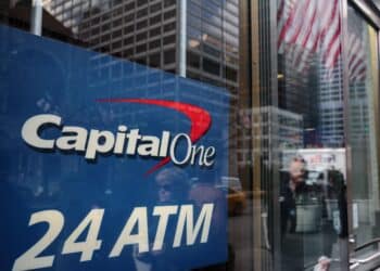 Pedestrians are reflected in the windows of a Capital One Financial Corp. bank branch in New York, U.S., Wednesday, Jan. 9, 2019. Capital One Financial Corp. is scheduled to release earnings figures on January 22. Photographer: Sarah Blesener/Bloomberg