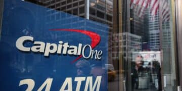 Pedestrians are reflected in the windows of a Capital One Financial Corp. bank branch in New York, U.S., Wednesday, Jan. 9, 2019. Capital One Financial Corp. is scheduled to release earnings figures on January 22. Photographer: Sarah Blesener/Bloomberg