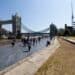 Visitors pass pass along the embankment near Tower Bridge in London, UK, on Saturday, June 10, 2023. Soaring temperatures caused by a blast of hot air led the UK to post fresh health warnings through the weekend. Photographer: Chris Ratcliffe/Bloomberg