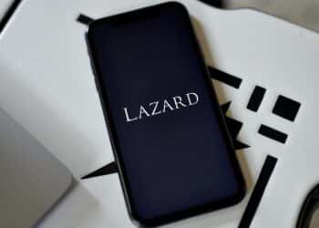 The Lazard logo on a smartphone arranged in the Brooklyn borough of New York, US, on Friday, April 28, 2023. Lazard Ltd. posted a surprise loss for the first quarter and said it plans to reduce its workforce by 10% this year, predicting the industrys dealmaking slump will last through 2023. Photographer: Gabby Jones/Bloomberg