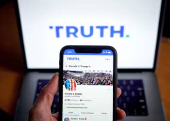 The Truth Social website on a smartphone arranged in New York, US, on Friday, March 22, 2024. Shareholders of Digital World Acquisition Corp., a publicly traded shell company, approved a deal to merge with the Trump's media business in a Friday vote. That means Trump Media & Technology Group, whose flagship product is social networking site Truth Social, will soon begin trading on the Nasdaq stock market, reported the AP. Photographer: Gabby Jones/Bloomberg via Getty Images