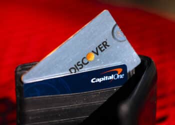 Capital One and Discover credit cards arranged in Rhinebeck, New York, US, on Tuesday, Feb. 20, 2024. Capital One Financial Corp. agreed to buy Discover Financial Services in a $35 billion all-stock deal to create the largest US credit card company by loan volume, giving the combined entity a stronger foothold to compete with Wall Streets behemoths.