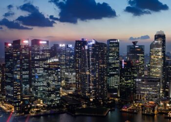 Commercial buildings illuminated at dusk in Singapore