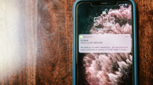 A fraud alert pings on a mobile phone