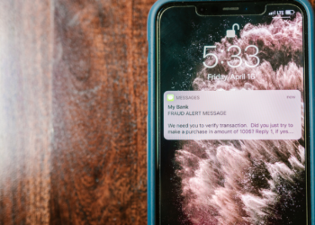 A fraud alert pings on a mobile phone