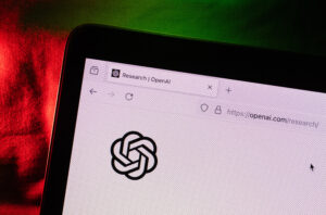 The OpenAI virtual assistant logo on a laptop compute