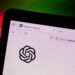 The OpenAI virtual assistant logo on a laptop compute