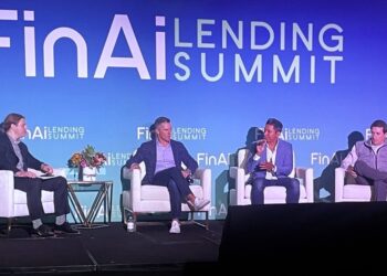 Four panelists on a stage with a large sign reading "FinAi Lending Summit" behind them